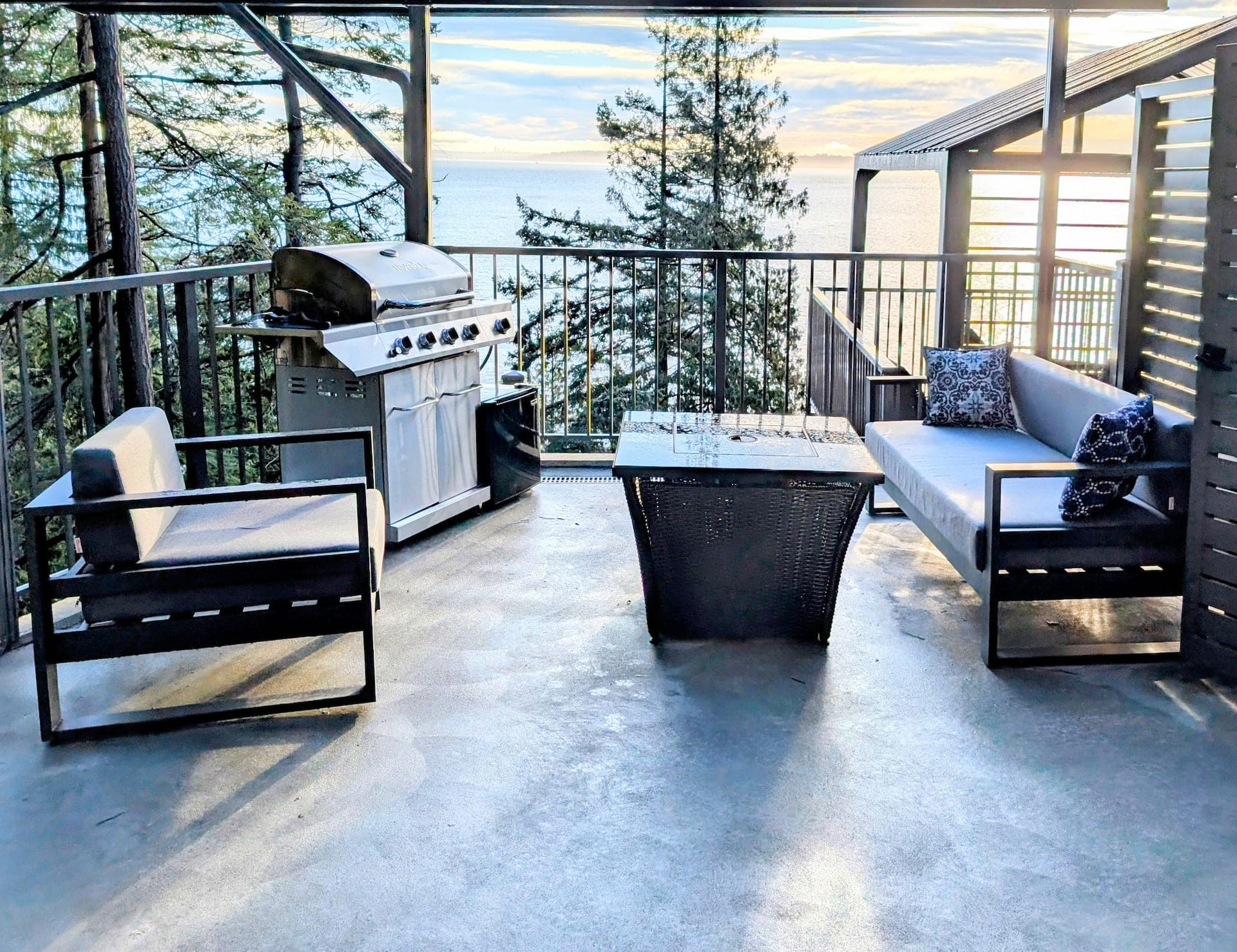 Deck with fire table and BBQ overlooking the ocean